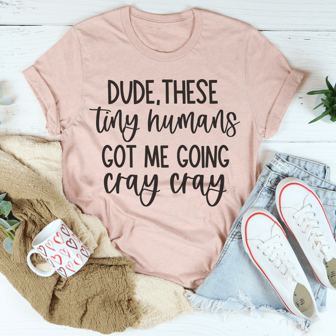 Blush pink graphic T-shirt with bold text "Dude, these tiny humans got me going"