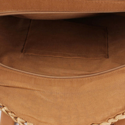 Interior of a sandy beige straw tote bag with fabric lining and visible zipper track