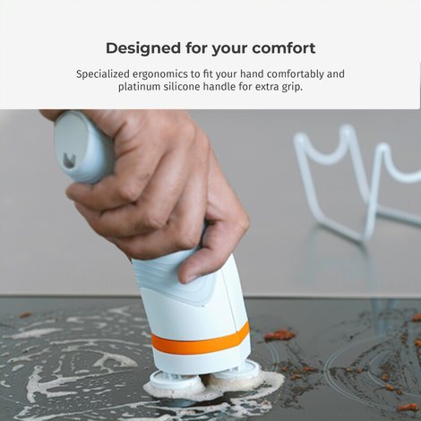 Cordless spin scrub brush with ergonomic handle in use on wet surface
