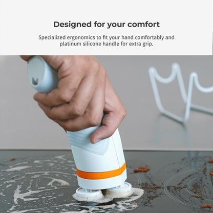Cordless spin scrub brush with ergonomic handle in use on wet surface