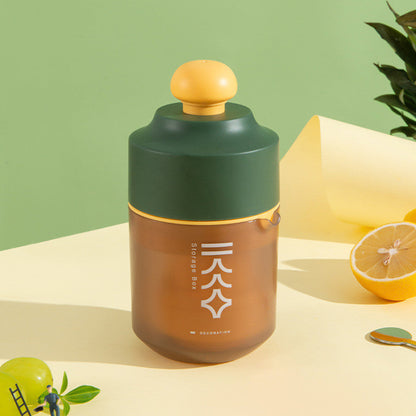 Portable manual citrus juicer with yellow squeeze top and green-brown container