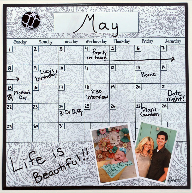 Dry erase calendar board with framed white grid and 'May' month header, paisley border