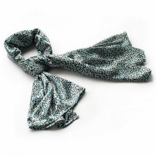 Leopard print silk scarf in teal and cream, loosely draped with twisted ends.