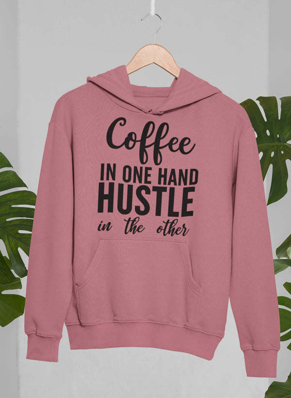 Mauve hoodie with front pocket and “Coffee in one hand hustle” graphic