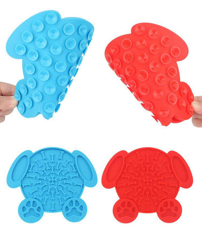 Blue and red bone-shaped dog lick mats with paw-print feet and raised ridged texture