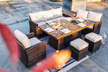 Patio conversation sofa set with glass-topped table, cushioned ottomans, and flaming firepit