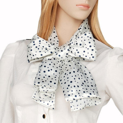 Silk scarf at collar with white and black dot print, gathered bow detail.
