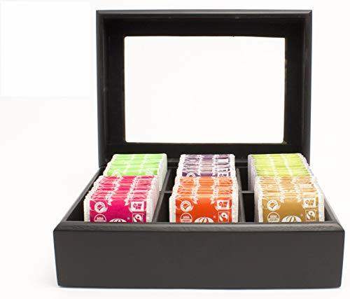 Black tea bag chest with compartments holding assorted tea sachet boxes.