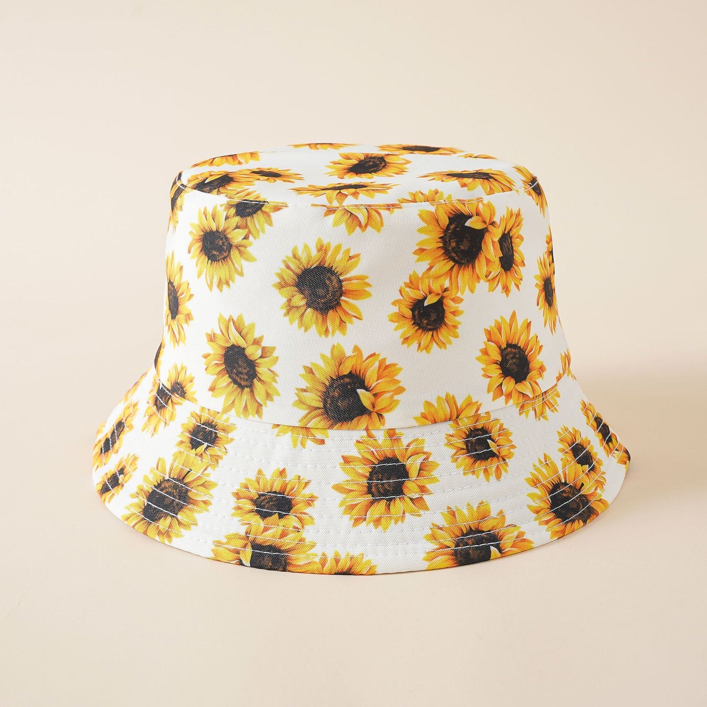 Double-sided fisherman hat in white with sunflower print and stitched bucket brim