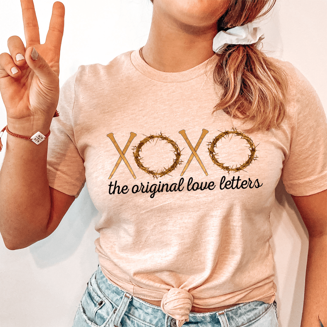 Heather peach T-shirt with XOXO graphic and “the original love letters” text