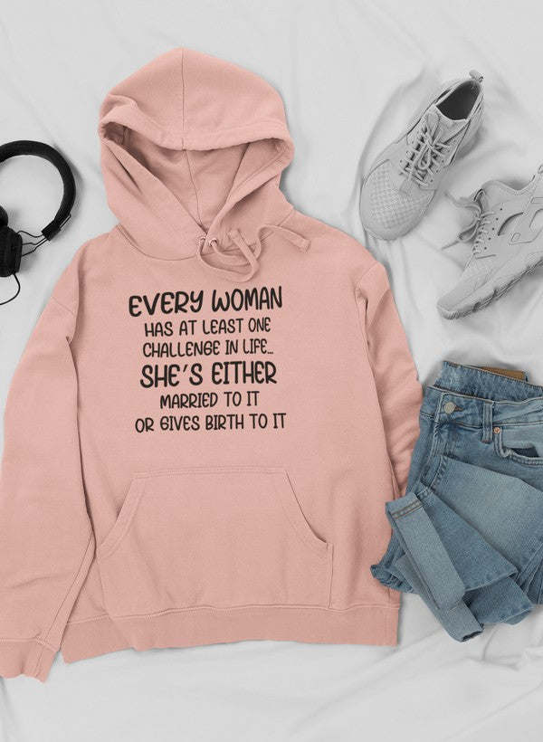 Pink hoodie with “Every Woman” quote graphic, drawstring hood, and kangaroo pocket.
