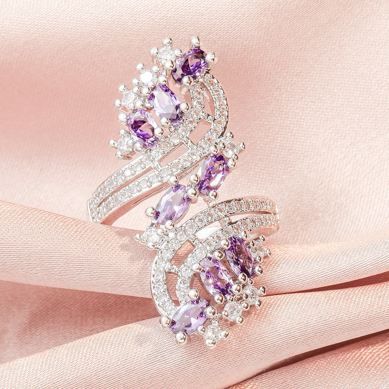 Purple amethyst zircon ring set with white sparkly stones on a silver-tone band