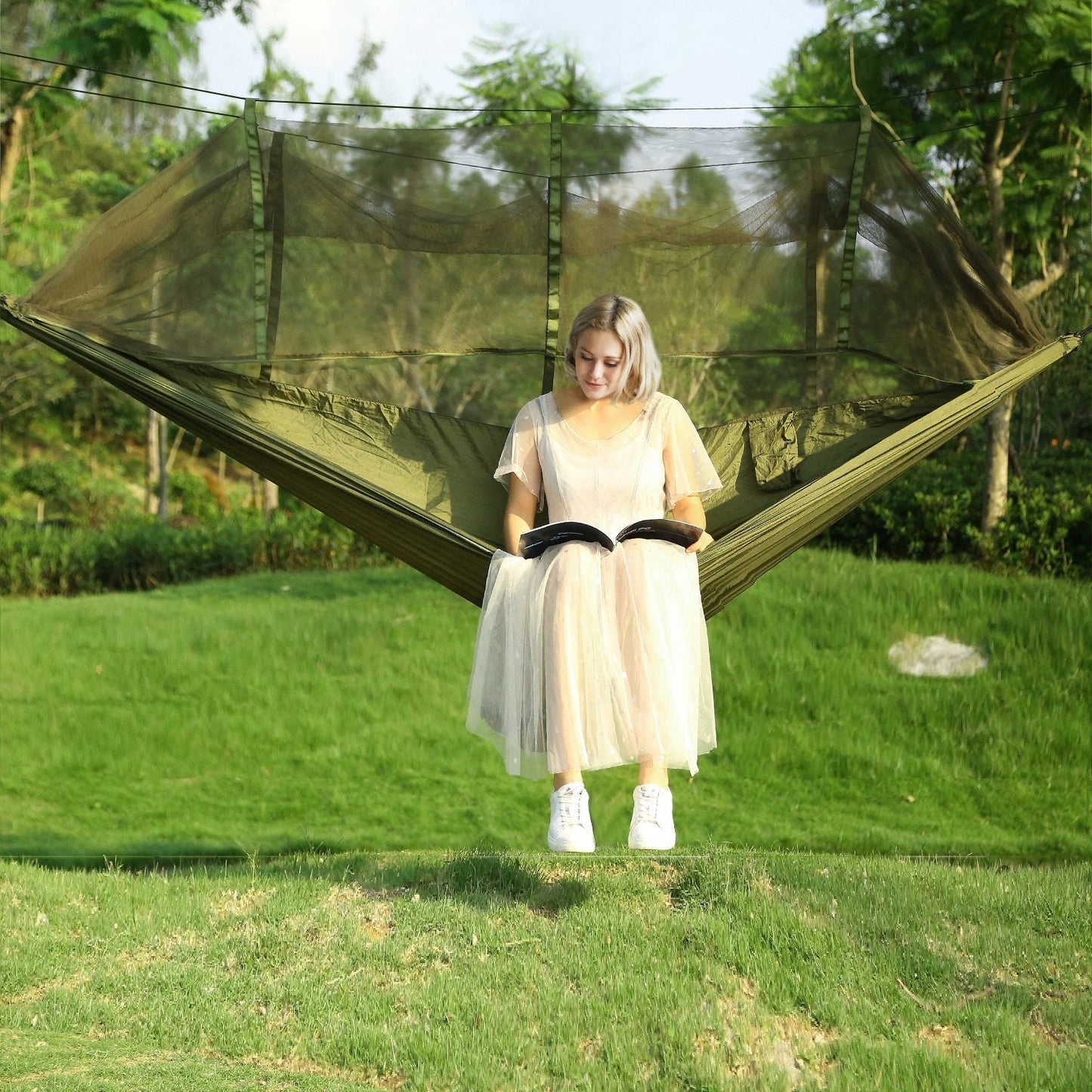 Two-person hammock with mosquito net canopy, green frame and mesh enclosure
