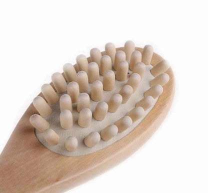 Bath massage brush with dense tan bristles on rounded wooden base
