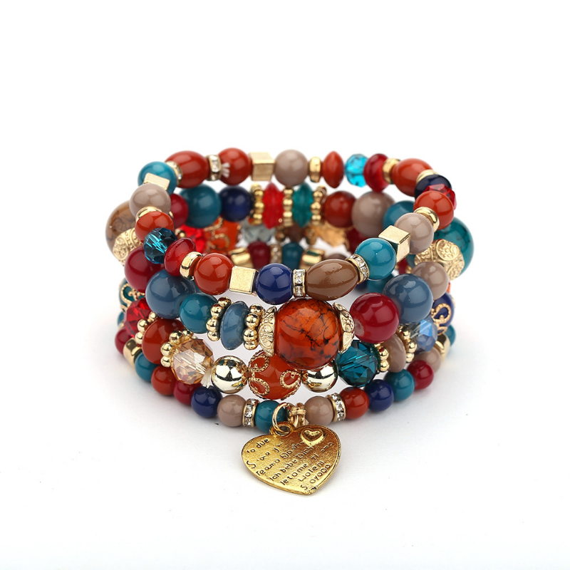 Layered charm bracelet set with multicolor beads, gold charms, and a heart pendant
