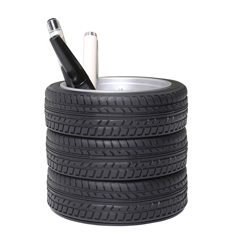 Black tire tread pen holder with two pens in the center cup