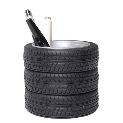 Black tire tread pen holder with two pens in the center cup