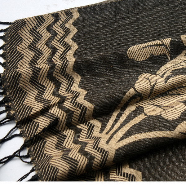 Close-up of pashmina shawl edge with zigzag pattern and black fringed tassels