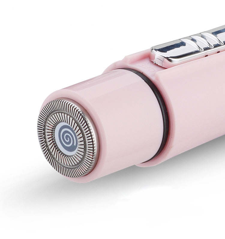 Pink grooming wand with round rotating shaving head and metal housing