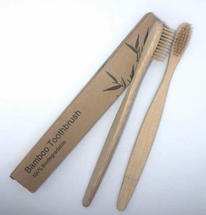 Two bamboo toothbrushes with packaged cardboard sleeve