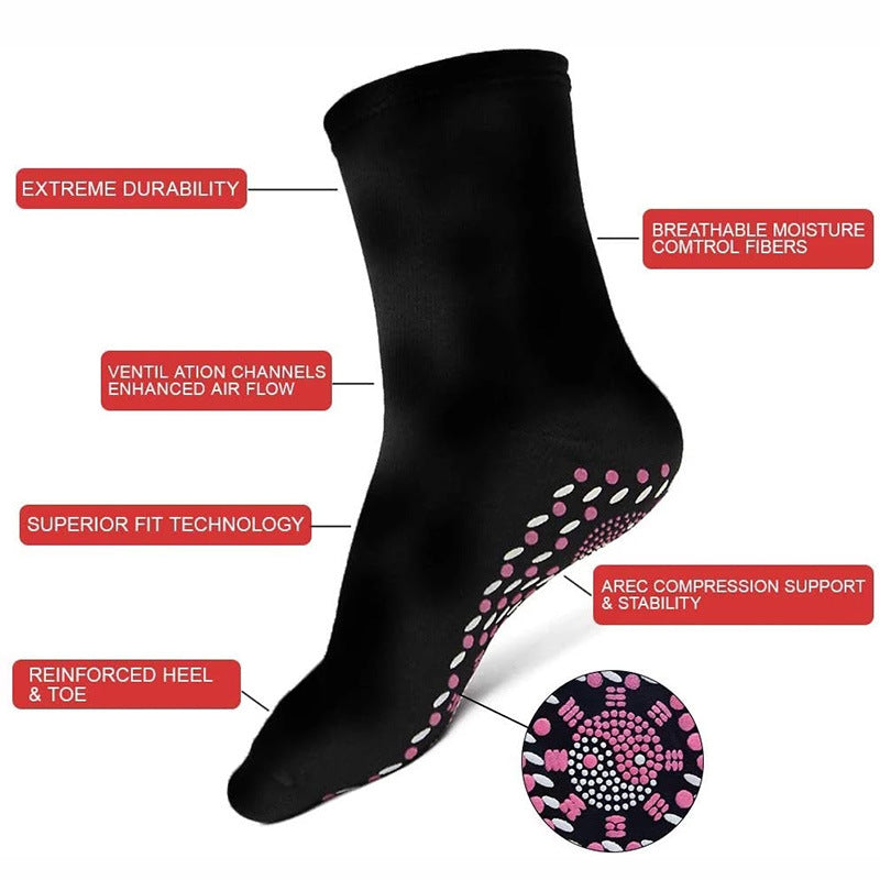 Black self-heating socks for women with pink dotted grip pattern on underside
