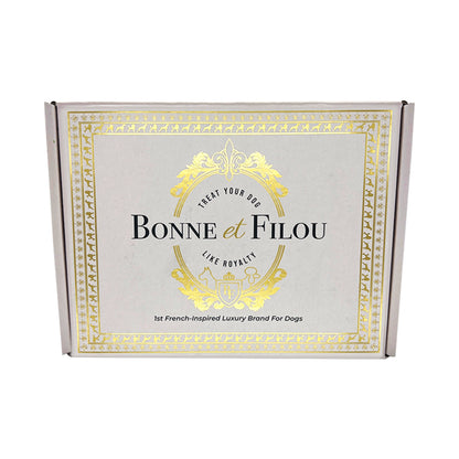 Bonne et Filou dog treats gift box with gold crest logo on gray.