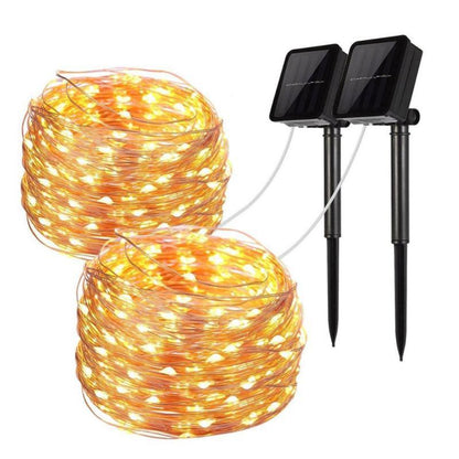 Solar string lights set with two small solar panels and a coiled warm-yellow light strand.
