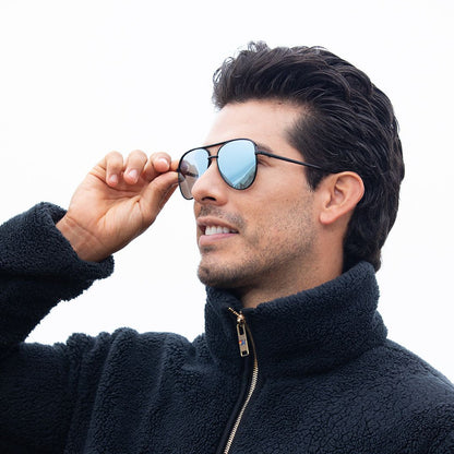 Polarized sunglasses on dark frames with blue mirrored lenses, held to face