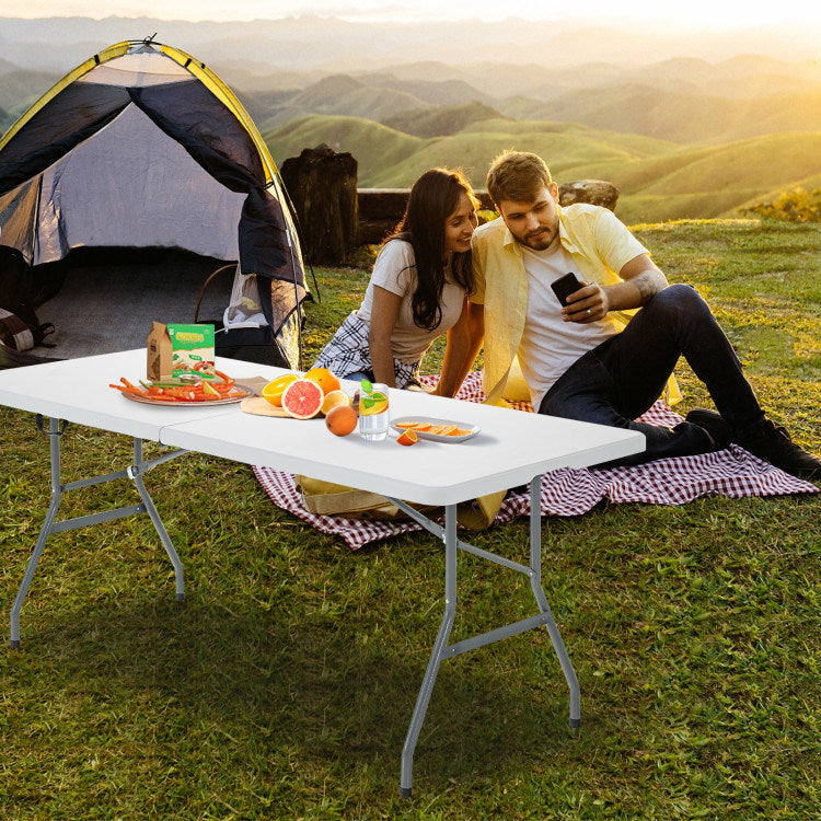 White portable folding camping table with gray metal legs for outdoor picnics