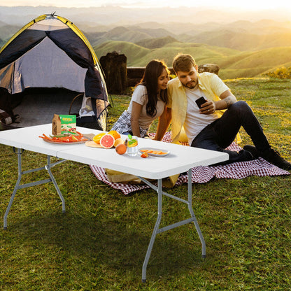White portable folding camping table with gray metal legs for outdoor picnics