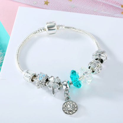 Silver charm bracelet with blue crystal and clear beads, angel and heart charm