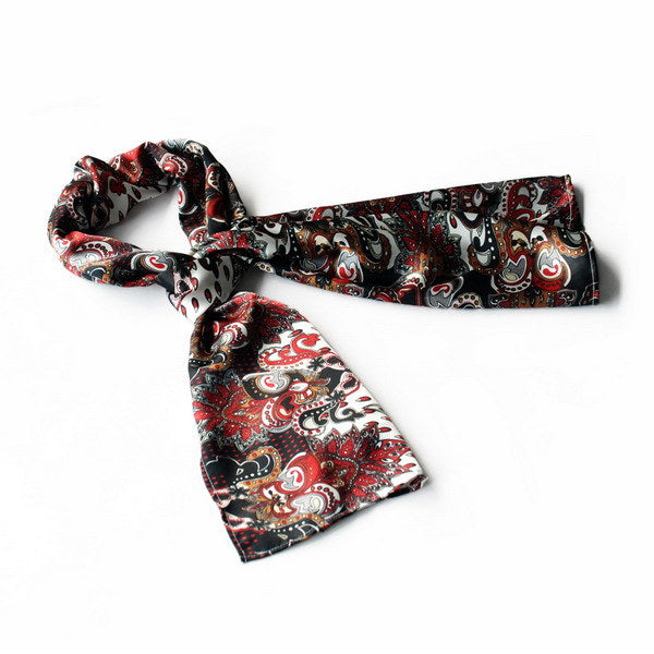 Large silk scarf with paisley print, black base with red and white swirls.