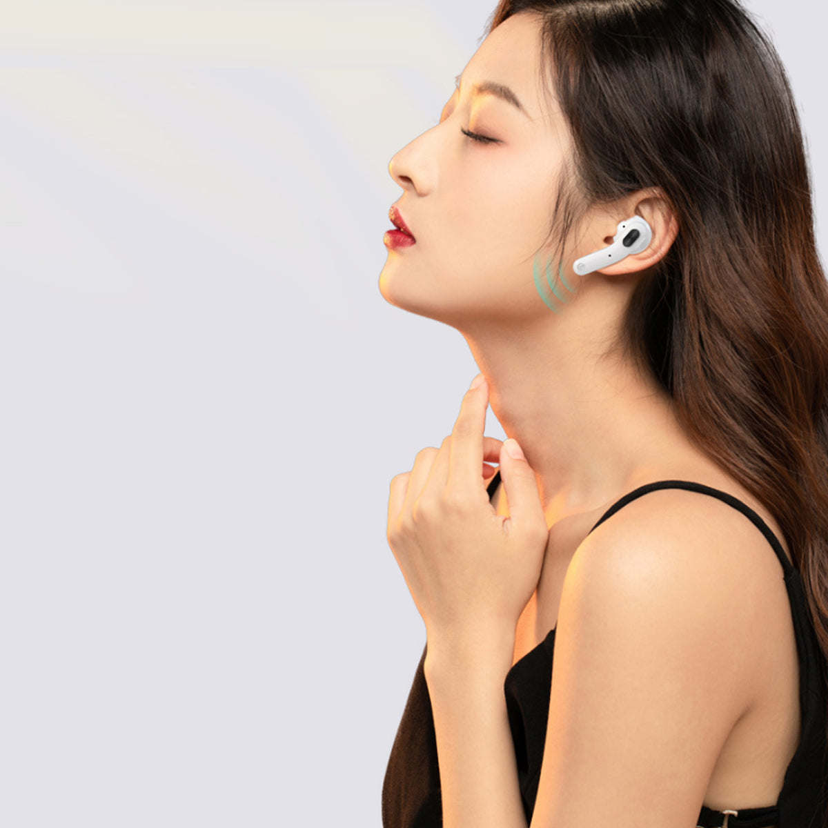 White Bluetooth earbuds in ear with small blue indicator on microphone stem