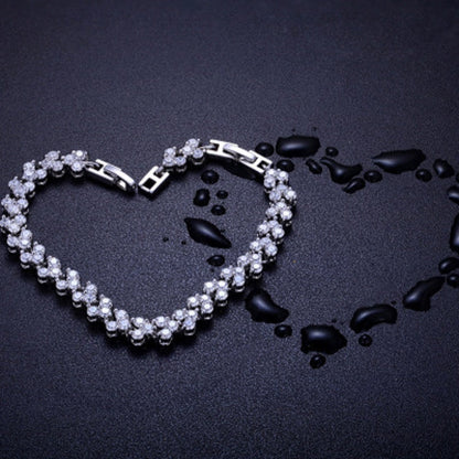 Silver tennis bracelet with oval curve of round rhinestone stones and clasp