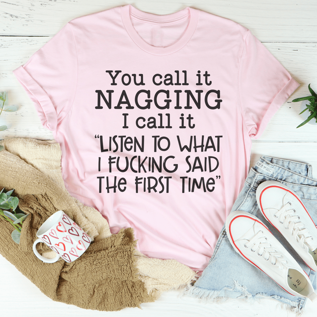 Pink graphic crew-neck T-shirt with white slogan: “You call it NAGGING…”