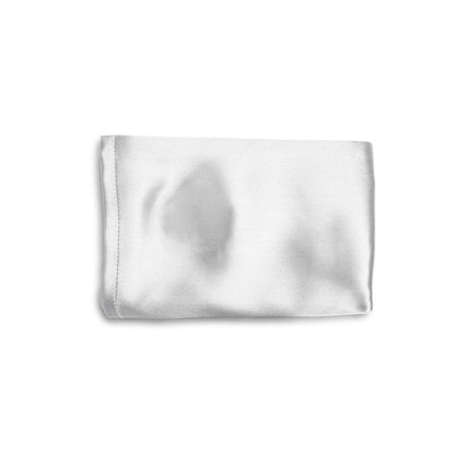 White silk pillowcase corner with visible stitched hem and soft sheen