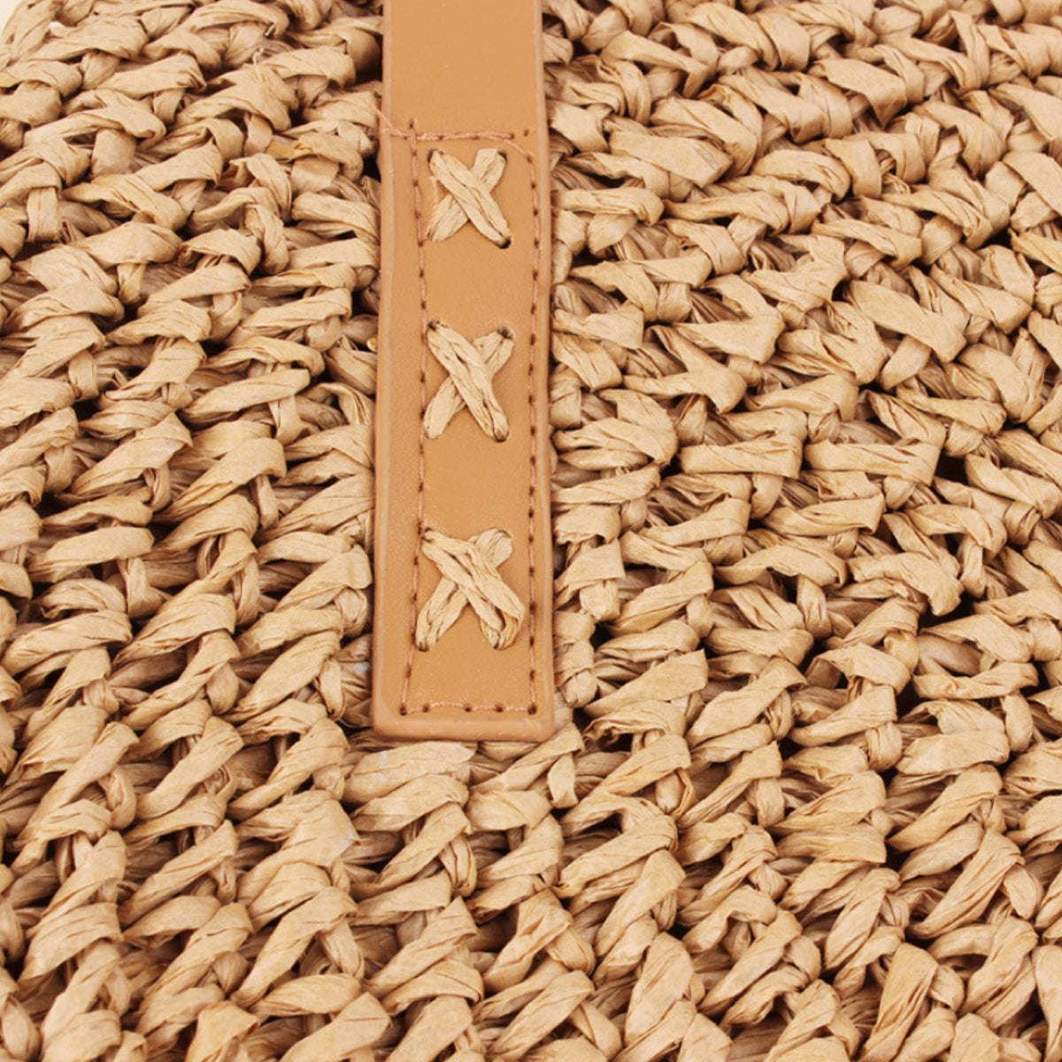 Sandy beige leather strap panel with starfish cutout accents on woven straw