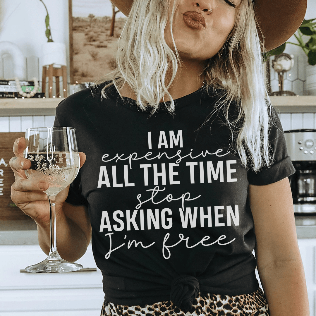 Black T-shirt with 'I am expensive all the time... I'm free' slogan; knotted hem