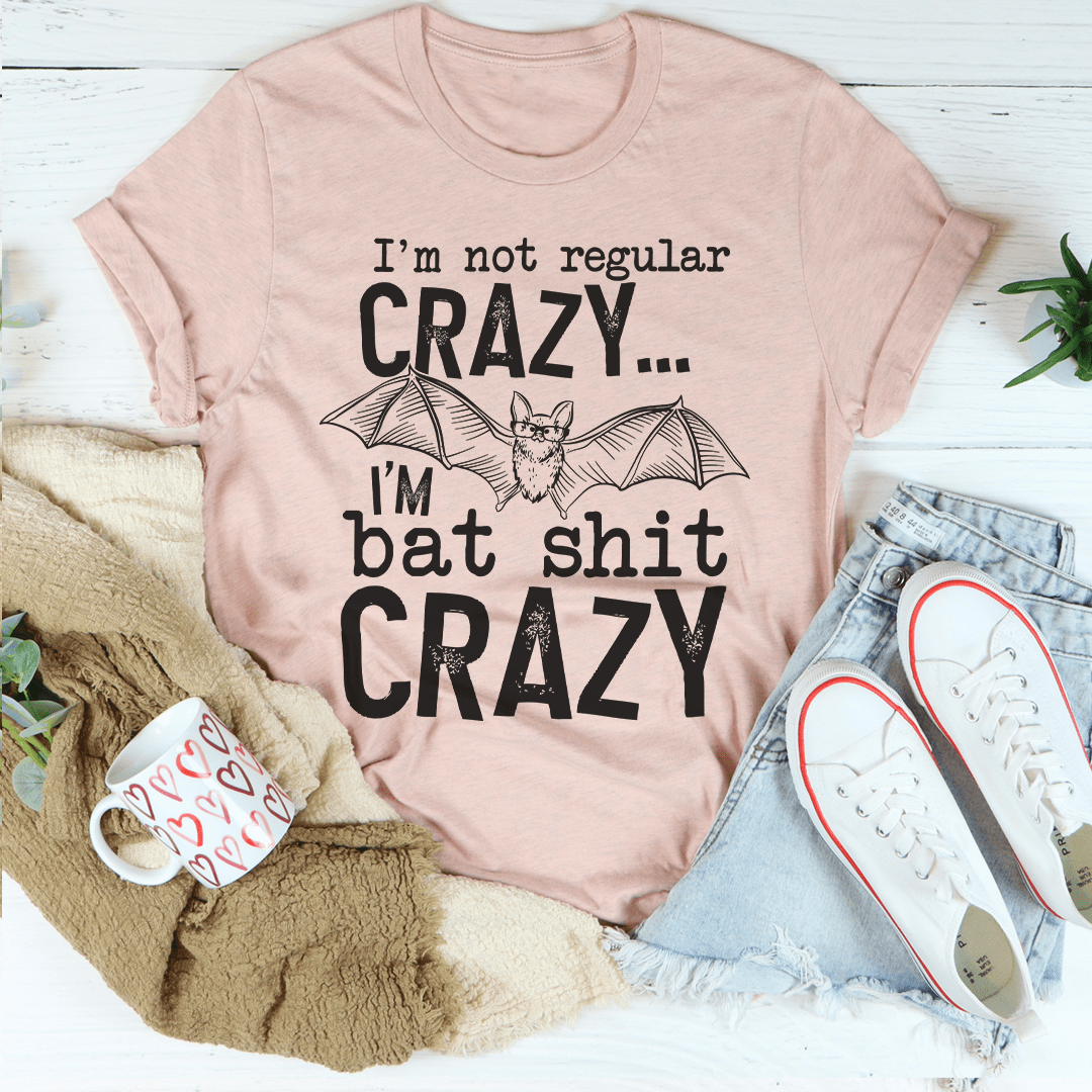 Light pink graphic T-shirt with bat graphic and 'Crazy' slogan text