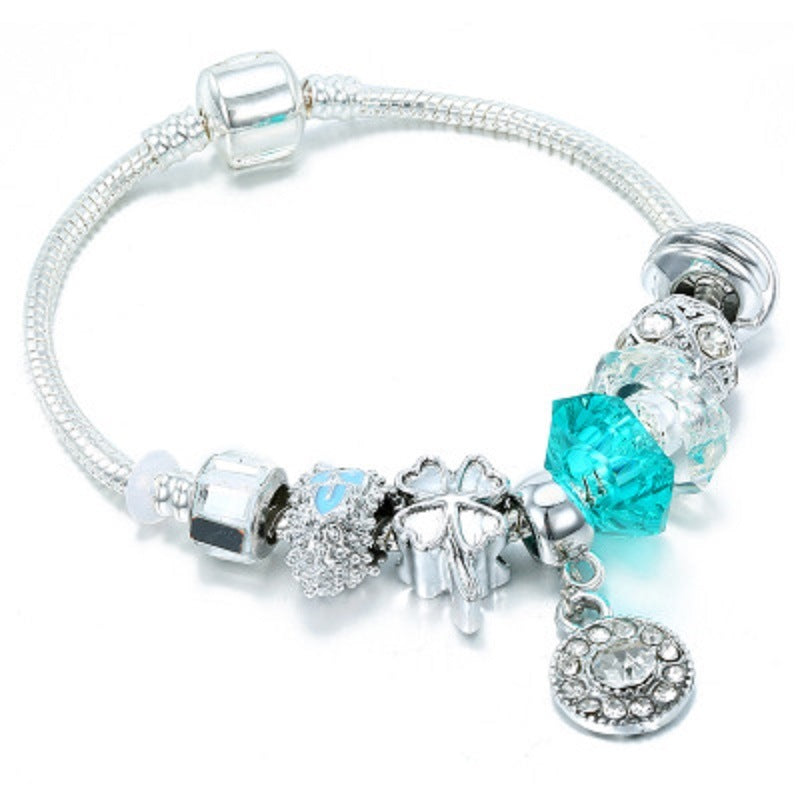Silver charm bracelet with blue crystal and glass beads, heart and angel charms
