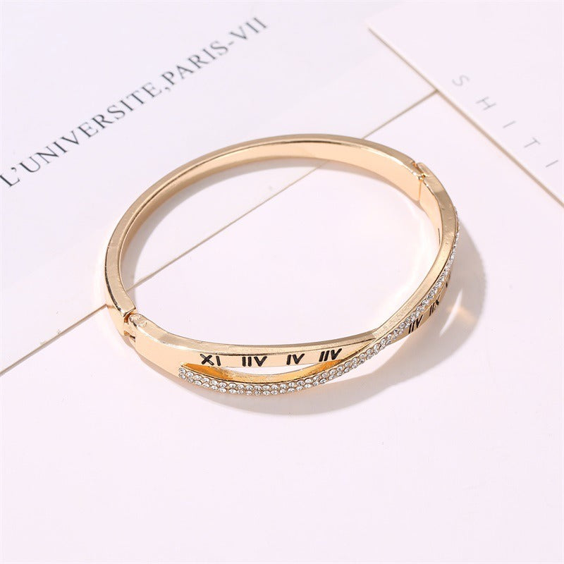 Gold-tone roman numeral bracelet bangle, rhinestone-embellished band with engraved Roman numerals