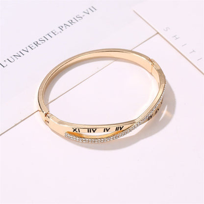 Gold-tone roman numeral bracelet bangle, rhinestone-embellished band with engraved Roman numerals