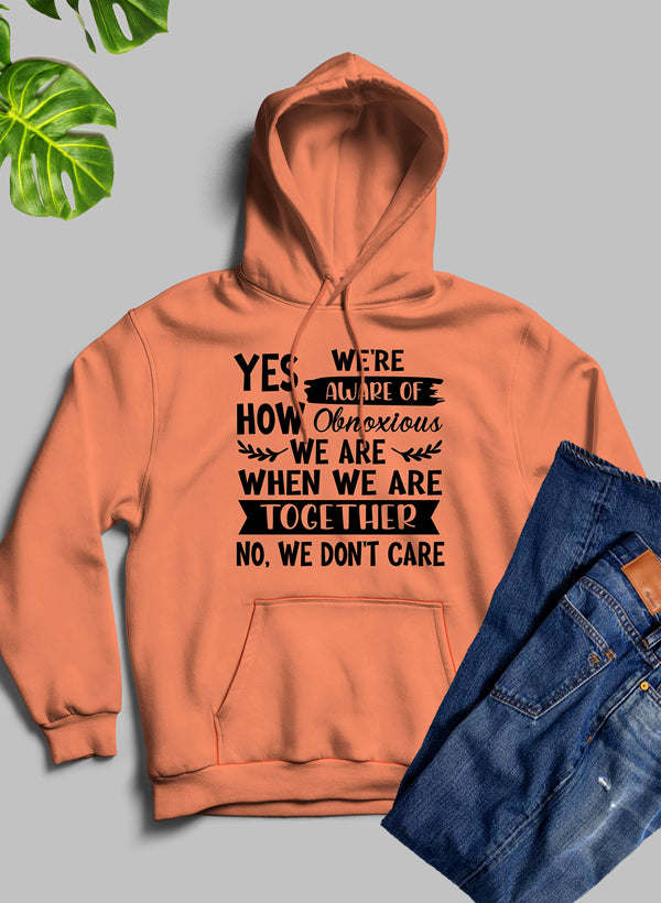 Orange hoodie with kangaroo pocket and large white text design on the chest, hooded