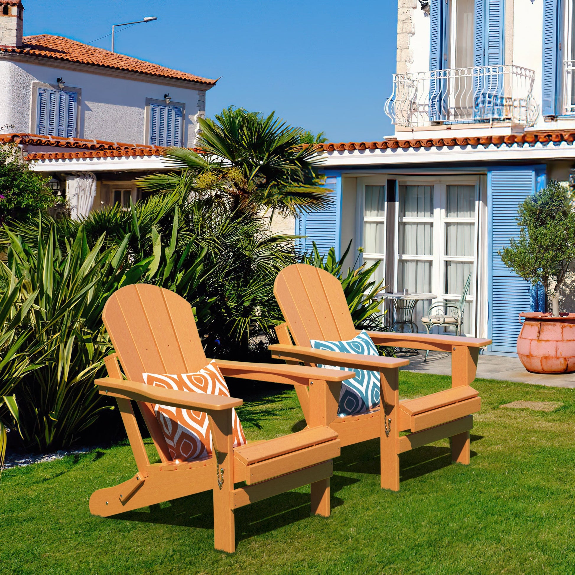 Set of two orange folding Adirondack chairs, slatted backs and seats