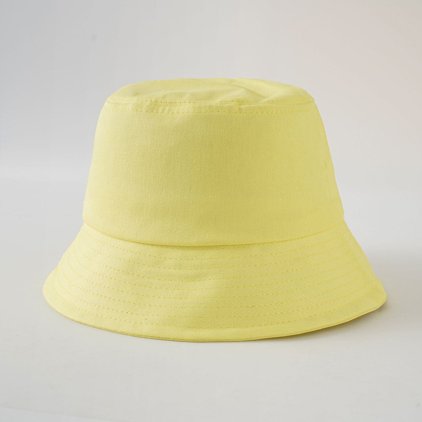 Yellow bucket fisherman hat with wide brim and stitched side panels