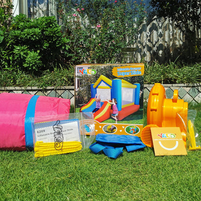 Inflatable bounce house set with accessories in yard; red, blue, and yellow inflatables