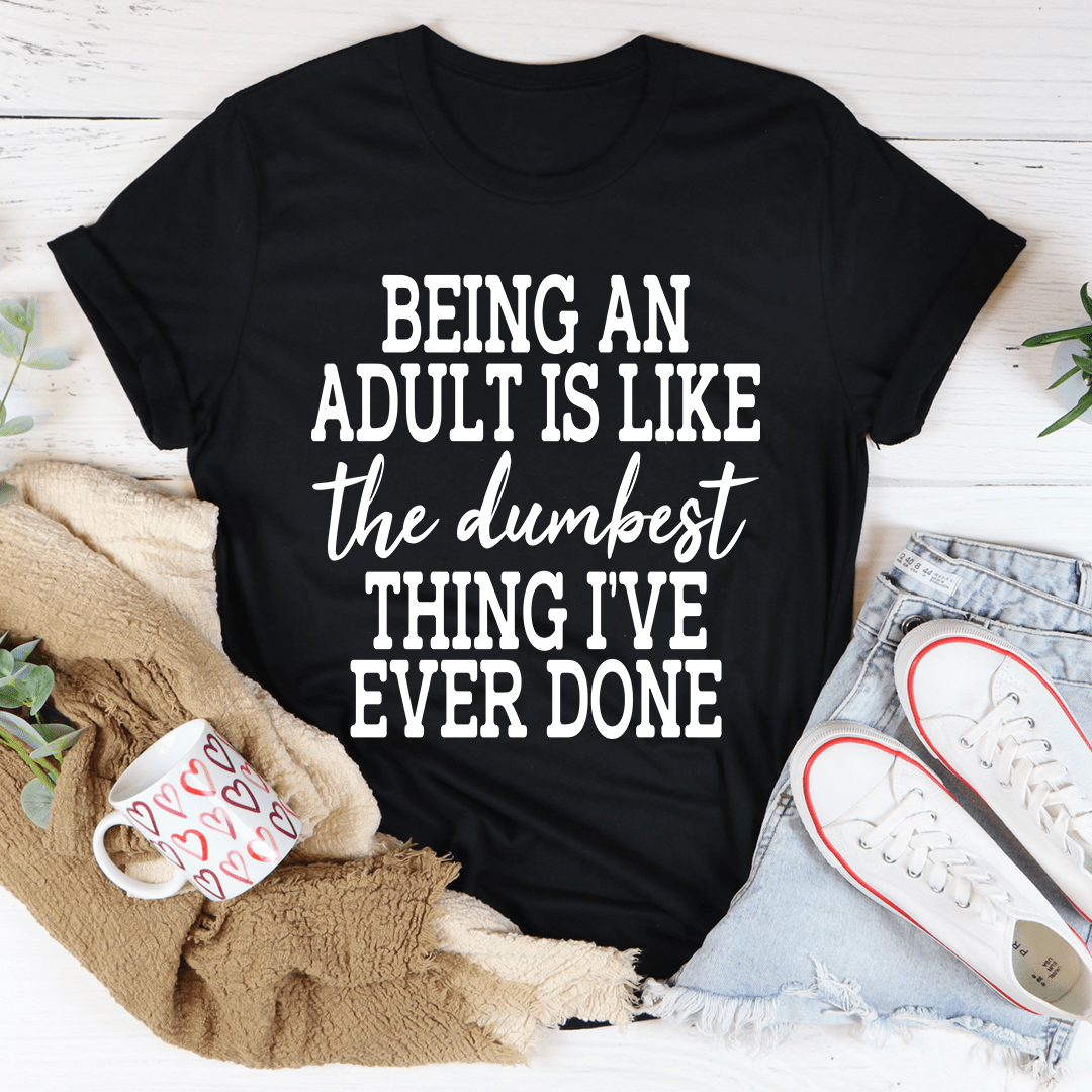 Black crewneck T-shirt with 'BEING AN ADULT IS LIKE' slogan