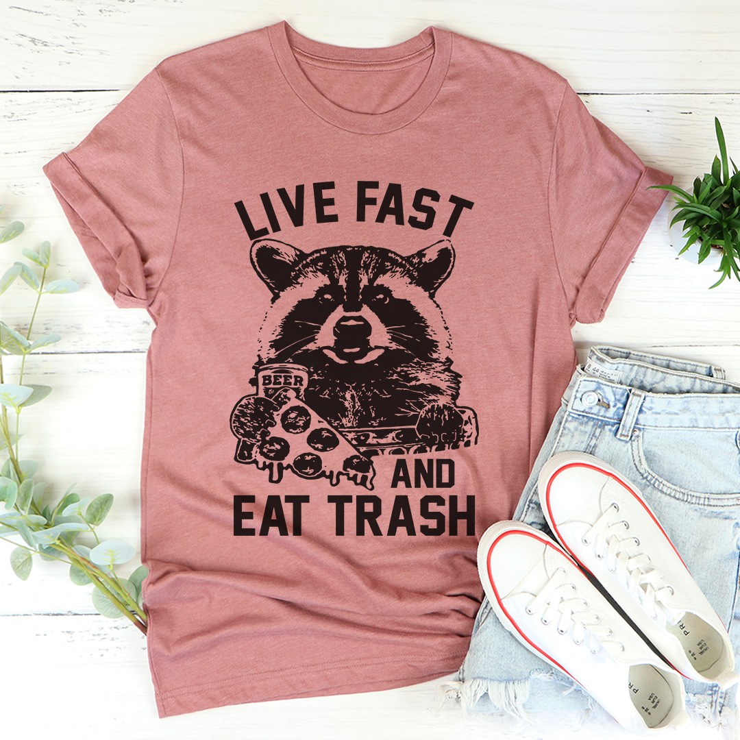 Mauve T-shirt with dark raccoon graphic and Live Fast and Eat Trash lettering