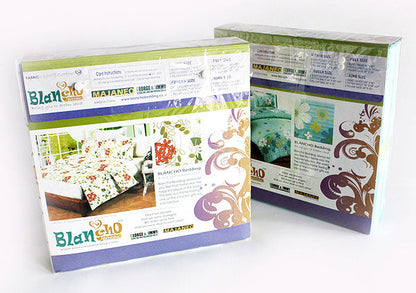 Two mini comforter set boxes with green and brown floral pattern designs