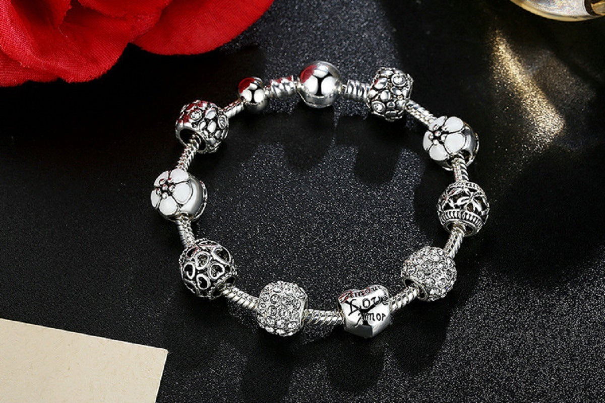 Silver-tone charm bracelet with sparkling bead charms and heart centerpiece